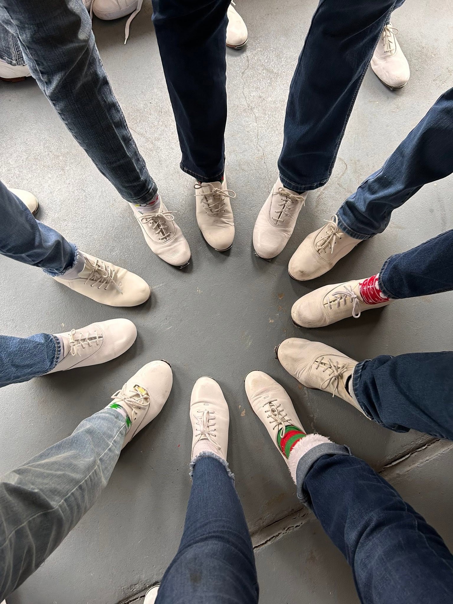 Cloggers standing in a circle with their white clogging shoes